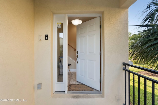 entrance to property with stucco siding