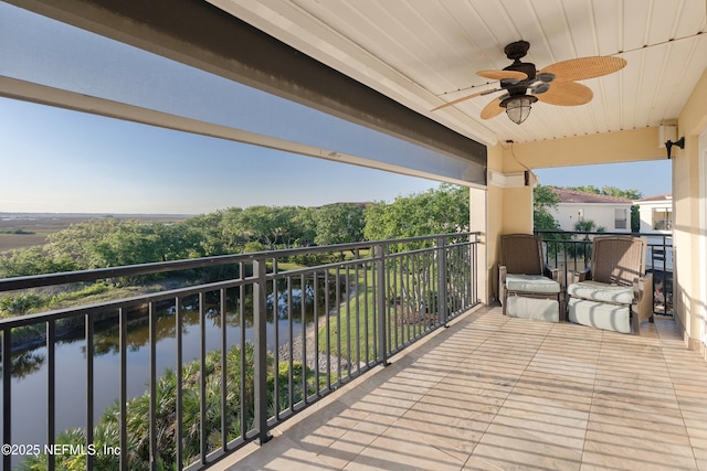 balcony with a ceiling fan and a water view