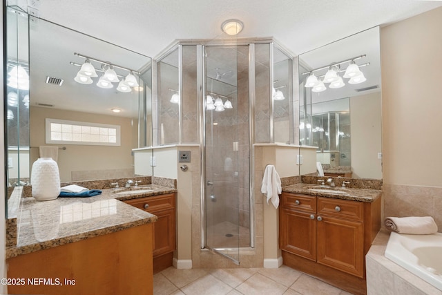 full bath with a shower stall, tile patterned flooring, visible vents, and vanity