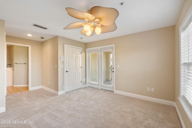 unfurnished bedroom with baseboards, visible vents, access to outside, and light colored carpet