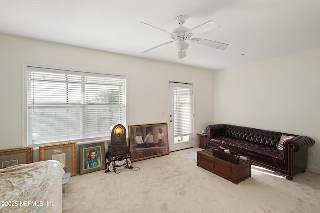 living room with a ceiling fan and carpet floors