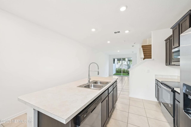 kitchen featuring light countertops, visible vents, dishwasher, a sink, and electric range oven