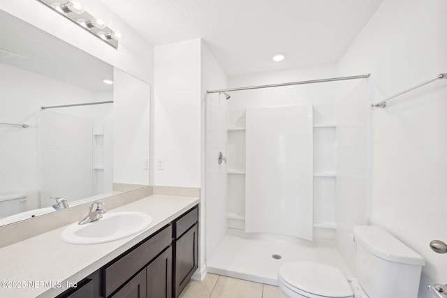 full bath with toilet, vanity, tile patterned flooring, and walk in shower