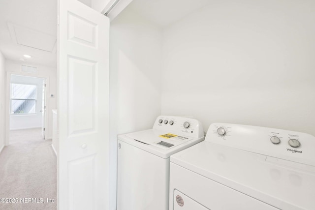 laundry area with light colored carpet, separate washer and dryer, visible vents, and laundry area
