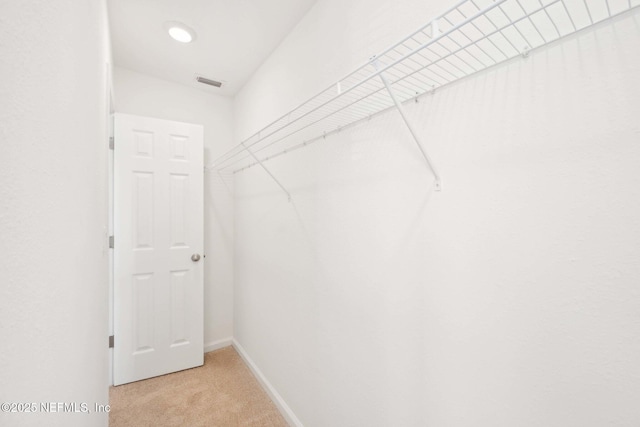 spacious closet with light carpet and visible vents