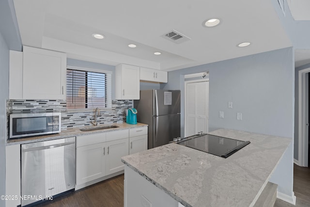731 1st St S Unit 311, Jacksonville Beach, FL 32250 - kitchen featuring white cabinetry, a sink, stainless steel appliances, and visible vents