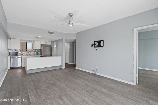 731 1st St S Unit 311, Jacksonville Beach, FL 32250 - unfurnished living room featuring baseboards, dark wood-style flooring, ceiling fan, and visible vents