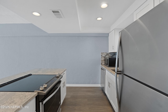 731 1st St S Unit 311, Jacksonville Beach, FL 32250 - kitchen featuring light countertops, visible vents, white cabinets, appliances with stainless steel finishes, and dark wood-style floors