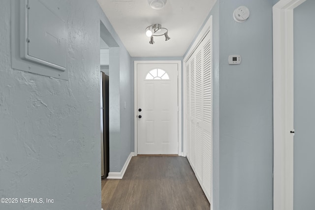 731 1st St S Unit 311, Jacksonville Beach, FL 32250 - entryway featuring dark wood finished floors, a textured wall, baseboards, and electric panel