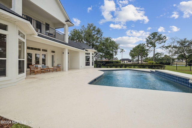 view of swimming pool with fence, french doors, a patio area, and a fenced in pool