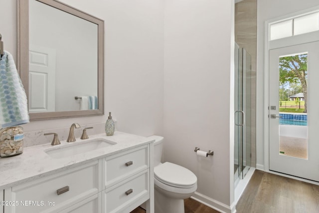 4520 Swilcan Bridge Ln N, Jacksonville, FL 32224 - full bathroom featuring wood finished floors, vanity, a stall shower, toilet, and baseboards