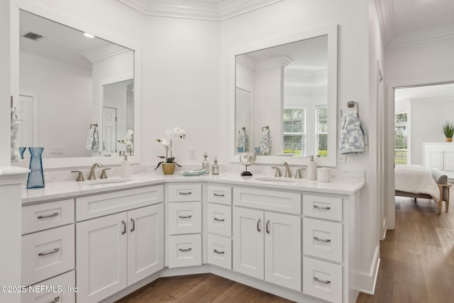 4520 Swilcan Bridge Ln N, Jacksonville, FL 32224 - bathroom featuring crown molding, wood finished floors, double vanity, and ensuite bathroom