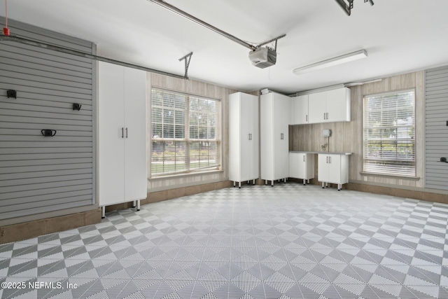 4520 Swilcan Bridge Ln N, Jacksonville, FL 32224 - garage featuring a garage door opener and wood walls