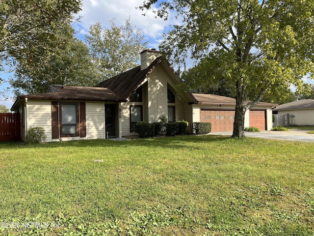 mid-century home featuring an attached garage, driveway, a chimney, and a front lawn