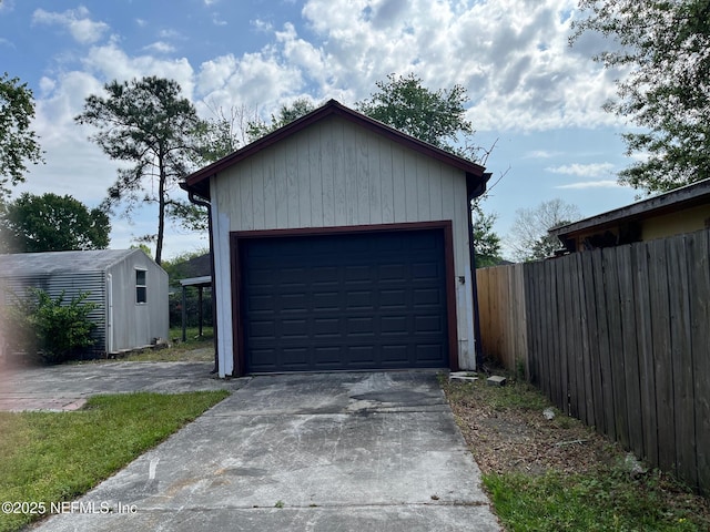 detached garage featuring fence