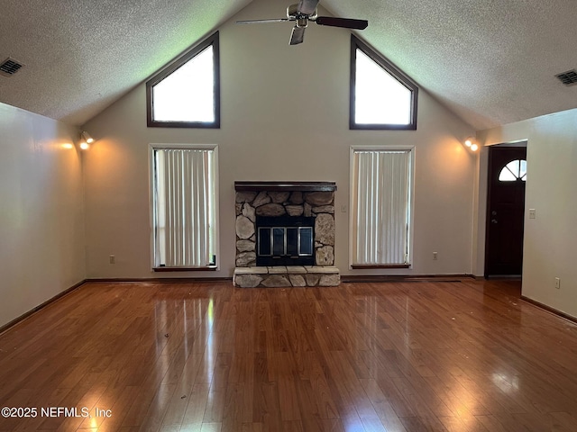 unfurnished living room with a ceiling fan, a textured ceiling, and high vaulted ceiling