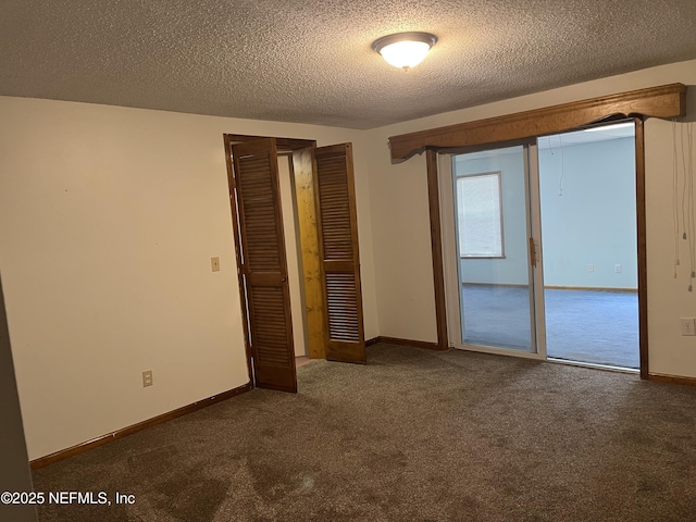 1933 Timucua Trl, Middleburg, FL 32068 - unfurnished bedroom featuring dark carpet, a textured ceiling, and a closet