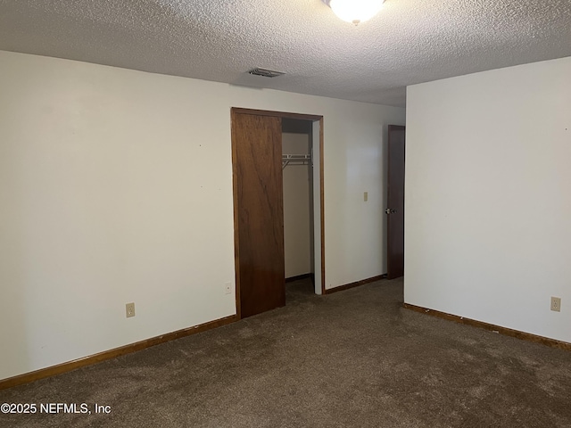1933 Timucua Trl, Middleburg, FL 32068 - unfurnished bedroom with carpet flooring, a closet, and a textured ceiling