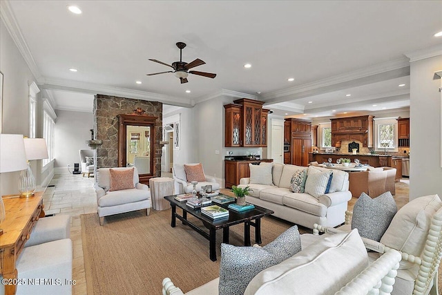 living room with crown molding, stone finish flooring, baseboards, ceiling fan, and recessed lighting
