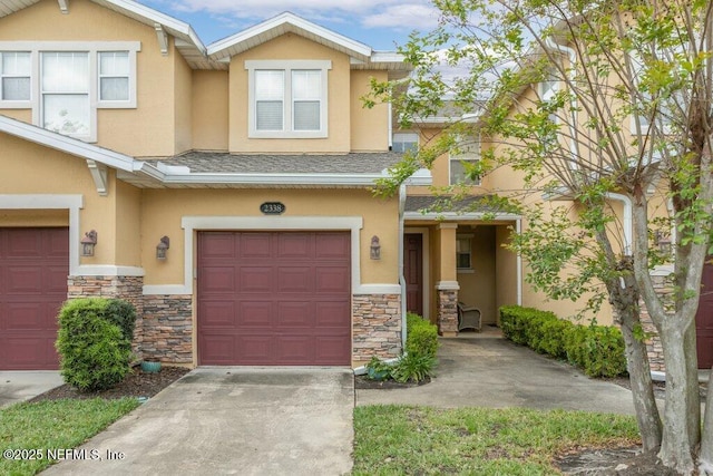 2338 Red Moon Dr, Jacksonville, FL 32216 - multi unit property featuring stucco siding, an attached garage, stone siding, and concrete driveway