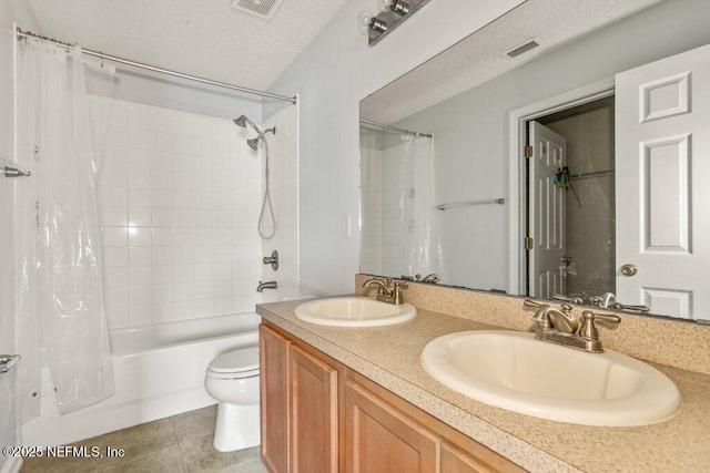 2338 Red Moon Dr, Jacksonville, FL 32216 - full bathroom with shower / bath combo with shower curtain, a textured ceiling, a sink, and toilet