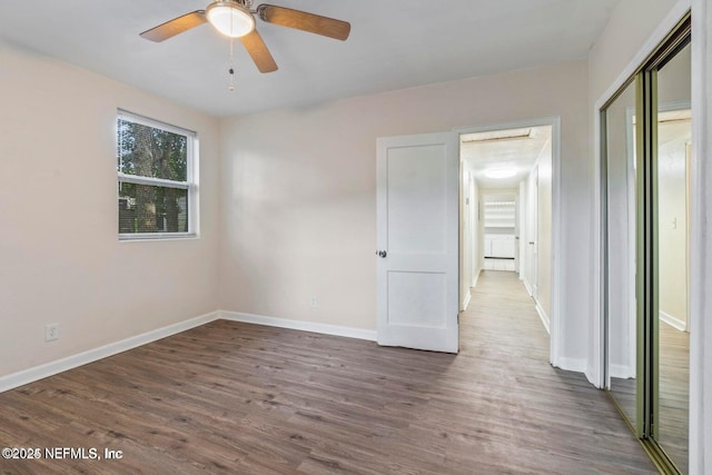 3047 Post St, Jacksonville, FL 32205 - unfurnished bedroom featuring baseboards, wood finished floors, a closet, and a ceiling fan