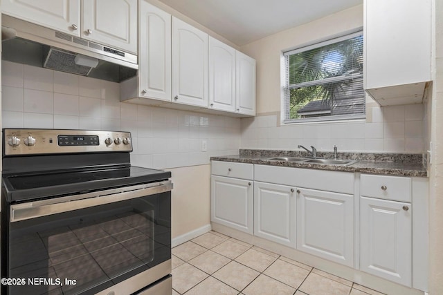 3047 Post St, Jacksonville, FL 32205 - kitchen featuring a sink, under cabinet range hood, light tile patterned floors, electric stove, and white cabinets