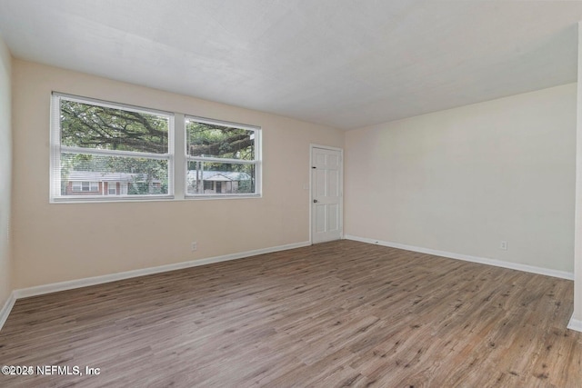 3047 Post St, Jacksonville, FL 32205 - empty room with light wood finished floors, baseboards, and plenty of natural light