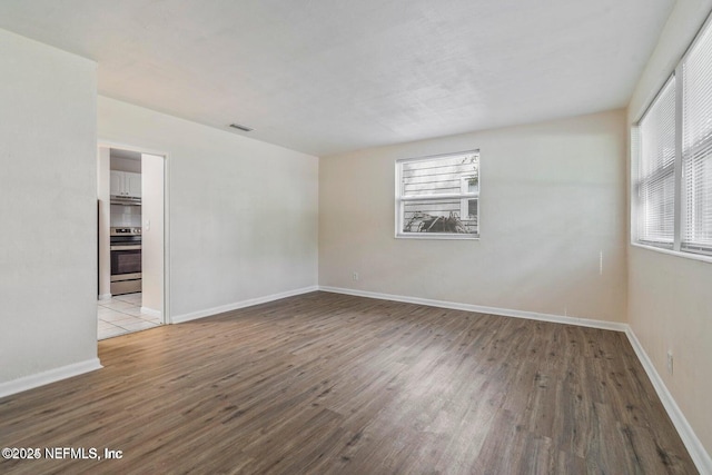 3047 Post St, Jacksonville, FL 32205 - spare room featuring visible vents, baseboards, and wood finished floors