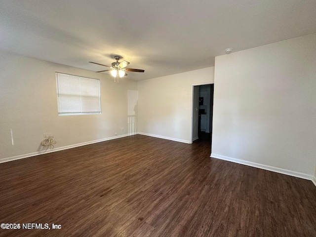 3047 Post St, Jacksonville, FL 32205 - empty room featuring dark wood-type flooring, ceiling fan, and baseboards