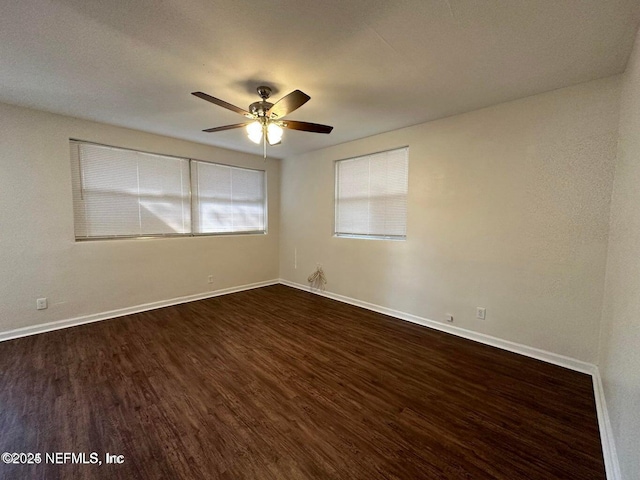 3047 Post St, Jacksonville, FL 32205 - empty room featuring a ceiling fan, dark wood-style floors, and baseboards