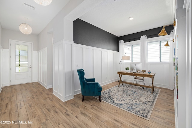 489 Windley Dr, Saint Augustine, FL 32092 - office area featuring light wood-style floors, a decorative wall, visible vents, and a wainscoted wall