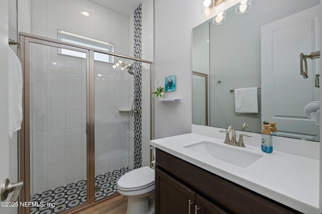 489 Windley Dr, Saint Augustine, FL 32092 - bathroom with toilet, a stall shower, wood finished floors, and vanity