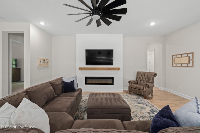 489 Windley Dr, Saint Augustine, FL 32092 - living room with a large fireplace, a ceiling fan, recessed lighting, wood finished floors, and baseboards
