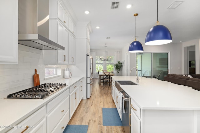 489 Windley Dr, Saint Augustine, FL 32092 - kitchen featuring light wood-type flooring, wall chimney exhaust hood, visible vents, and stainless steel appliances