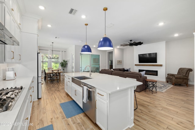 489 Windley Dr, Saint Augustine, FL 32092 - kitchen featuring visible vents, stainless steel appliances, light wood finished floors, ceiling fan with notable chandelier, and a sink