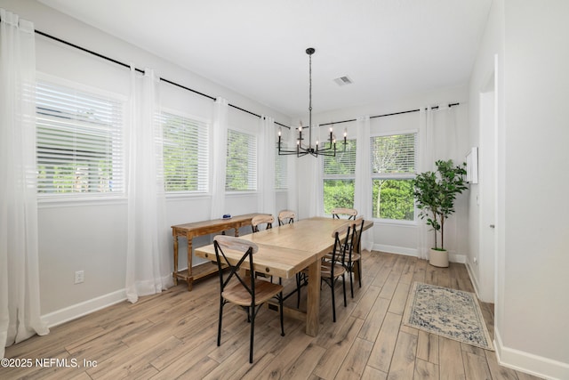489 Windley Dr, Saint Augustine, FL 32092 - dining space featuring a chandelier, baseboards, visible vents, and light wood-style flooring