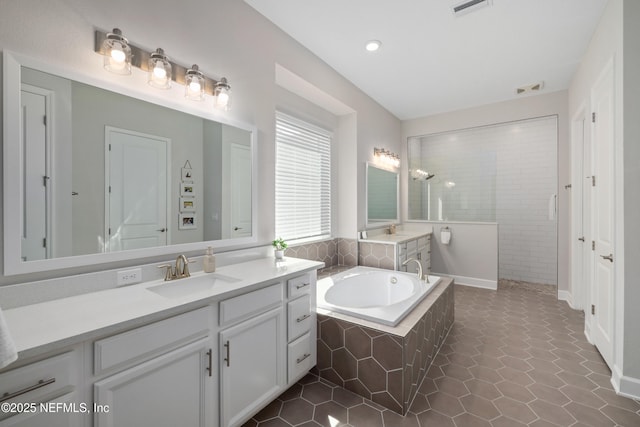 489 Windley Dr, Saint Augustine, FL 32092 - bathroom with a garden tub, vanity, visible vents, walk in shower, and tile patterned floors
