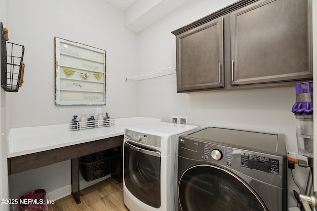 489 Windley Dr, Saint Augustine, FL 32092 - clothes washing area featuring cabinet space, separate washer and dryer, and light wood-style floors