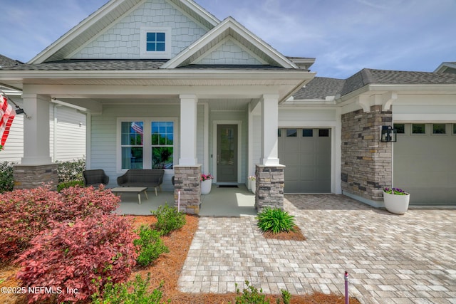 489 Windley Dr, Saint Augustine, FL 32092 - craftsman-style home with stone siding, decorative driveway, an attached garage, a shingled roof, and covered porch