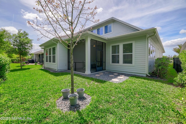 489 Windley Dr, Saint Augustine, FL 32092 - back of house with a yard, fence private yard, and a sunroom
