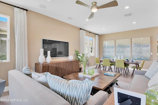 living room with ceiling fan, baseboards, visible vents, and recessed lighting