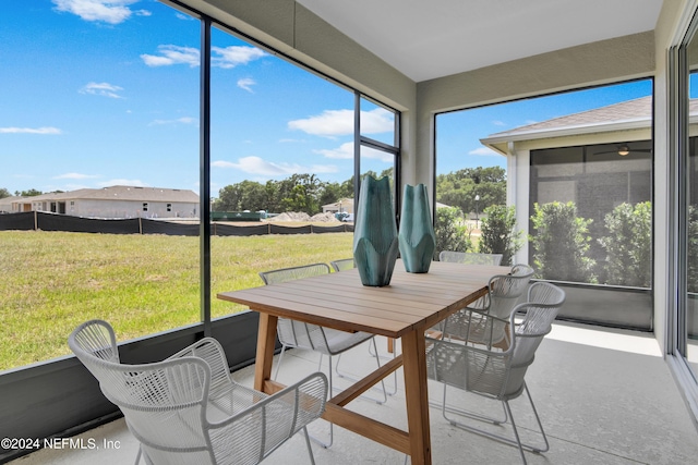 sunroom / solarium featuring outdoor dining space