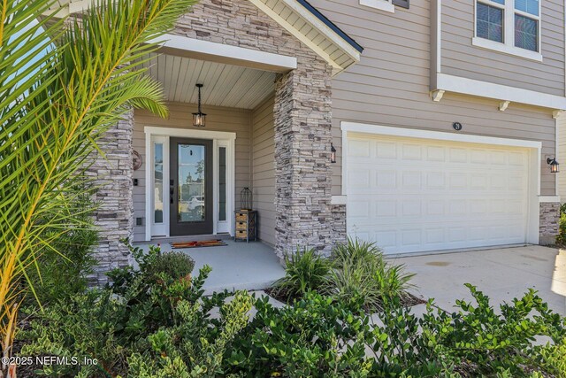 29 Stargaze Ln, Saint Augustine, FL 32095 - doorway to property featuring stone siding, concrete driveway, and an attached garage