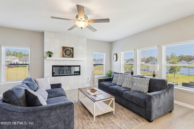 29 Stargaze Ln, Saint Augustine, FL 32095 - living area featuring wood finished floors, a ceiling fan, baseboards, and a tile fireplace