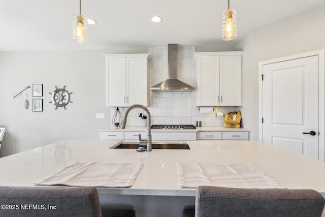 29 Stargaze Ln, Saint Augustine, FL 32095 - kitchen featuring wall chimney exhaust hood, a sink, backsplash, pendant lighting, and recessed lighting