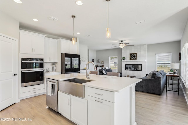 29 Stargaze Ln, Saint Augustine, FL 32095 - kitchen with dishwasher, smart refrigerator, a ceiling fan, a sink, and light wood-style floors