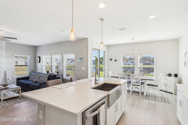 29 Stargaze Ln, Saint Augustine, FL 32095 - kitchen with a sink, open floor plan, light wood-style floors, white cabinets, and recessed lighting