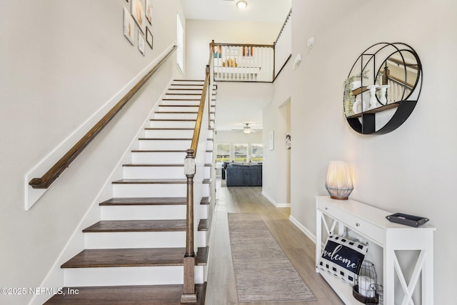 29 Stargaze Ln, Saint Augustine, FL 32095 - stairway featuring wood finished floors, ceiling fan, baseboards, and a high ceiling