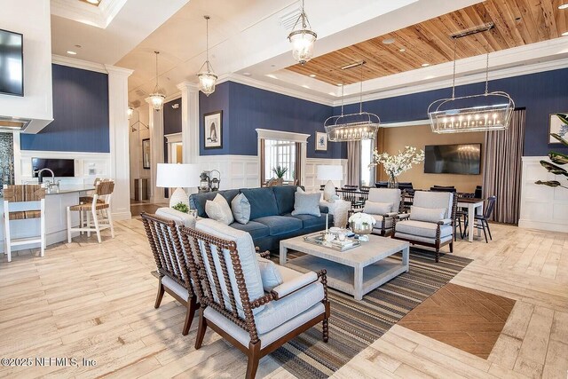 29 Stargaze Ln, Saint Augustine, FL 32095 - living area featuring a decorative wall, crown molding, hardwood / wood-style floors, wainscoting, and a raised ceiling